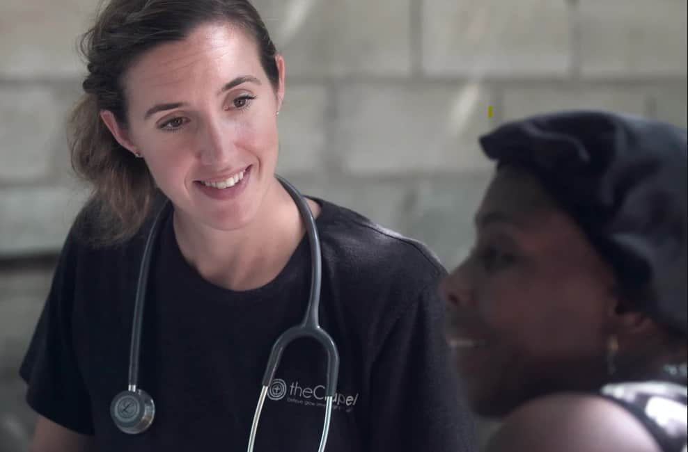 nurse wearing scrub suit attending to patient